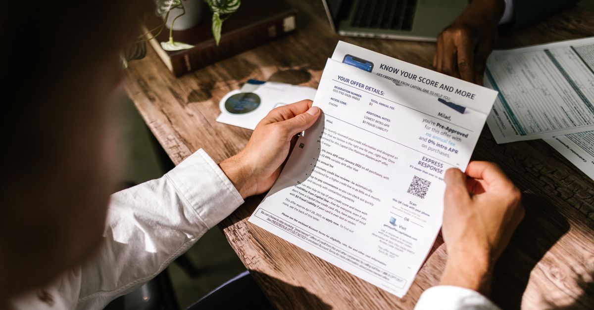 A person reading a printed data breach notification letter at a table