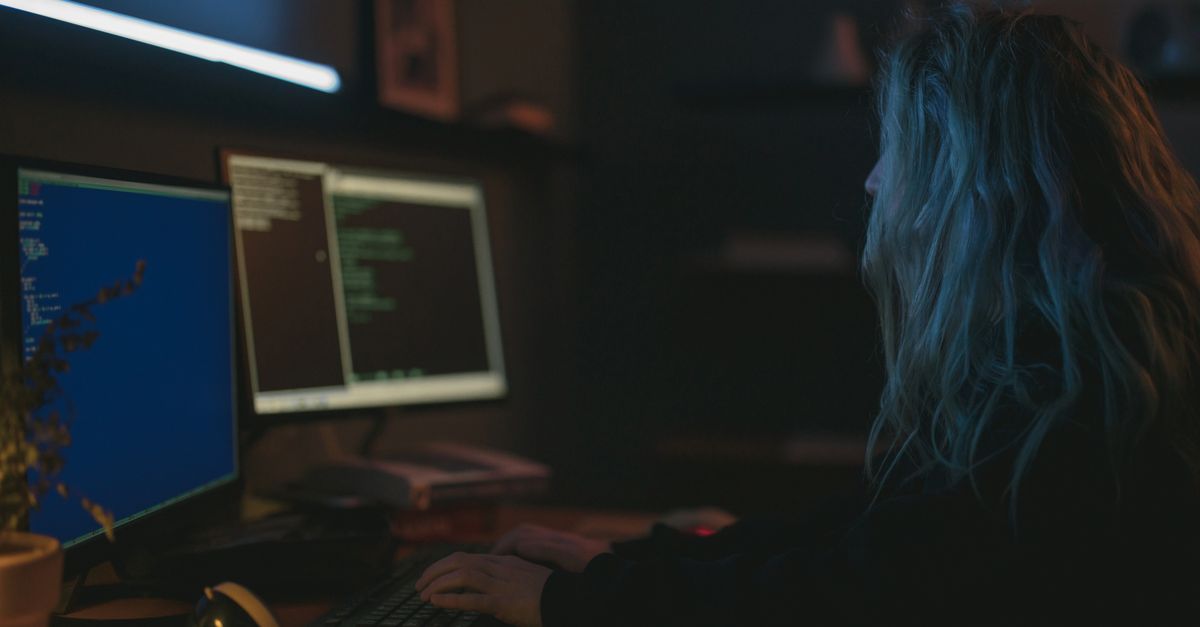 A security tester working across dual monitors during the active testing stage of a penetration test