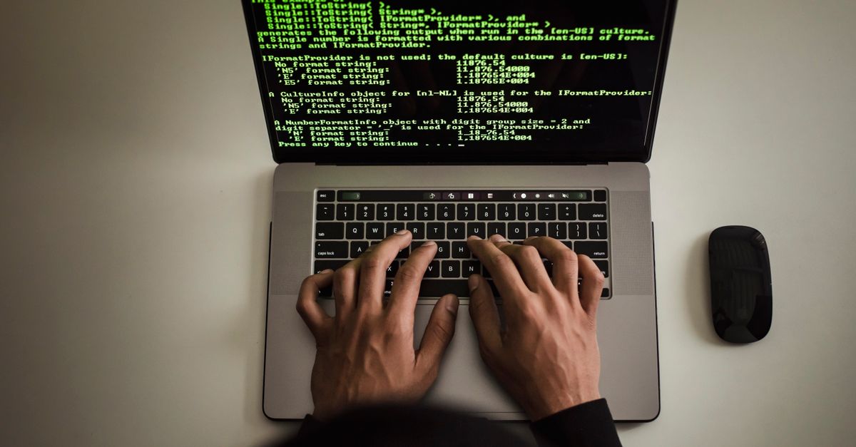 A tester's hands actively working at a laptop keyboard during a manual penetration test
