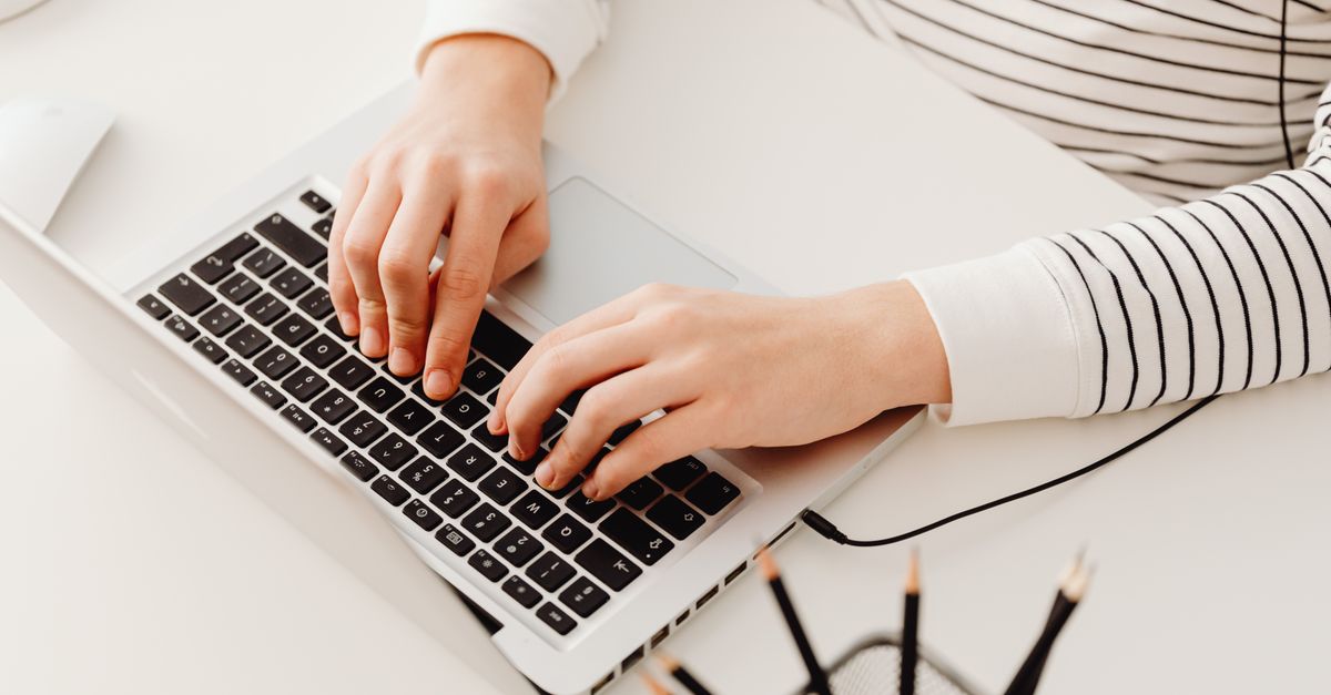 IT manager typing up evidence for cyber insurance penetration testing requirements