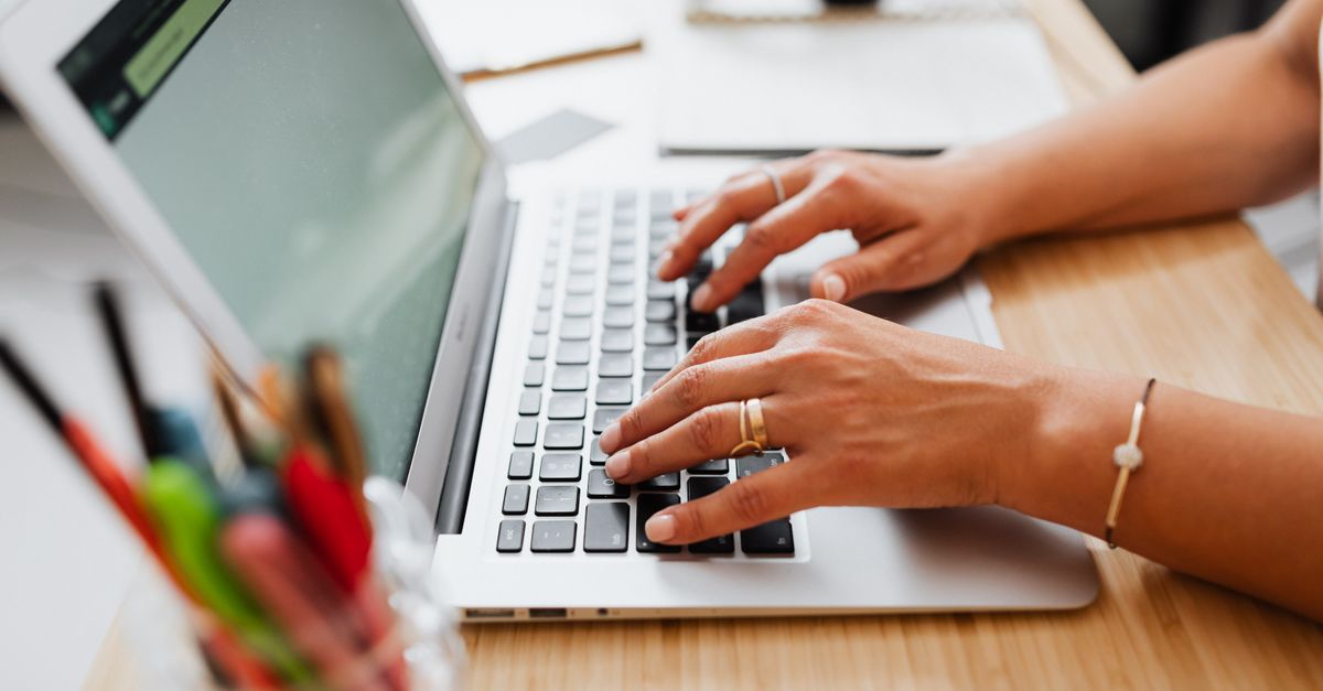 IT team member typing at a laptop while checking GlobalProtect authentication bypass patch status