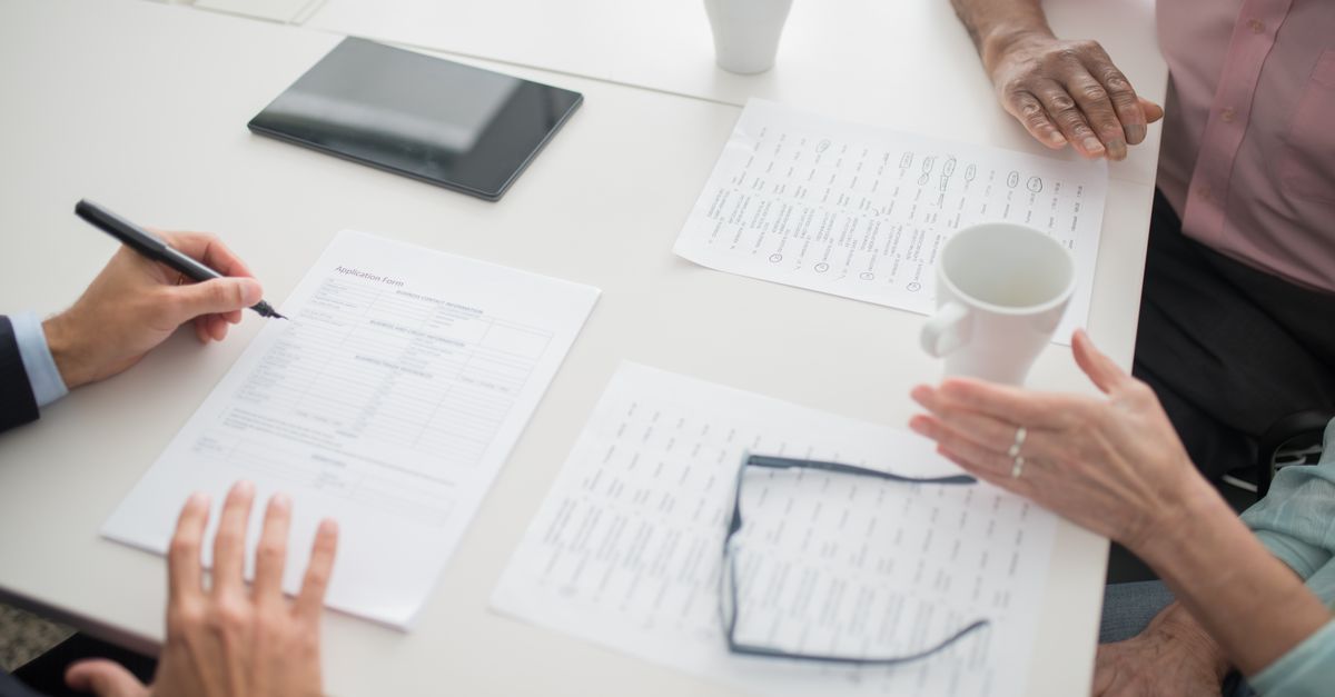 Two people reviewing a security report together at a desk