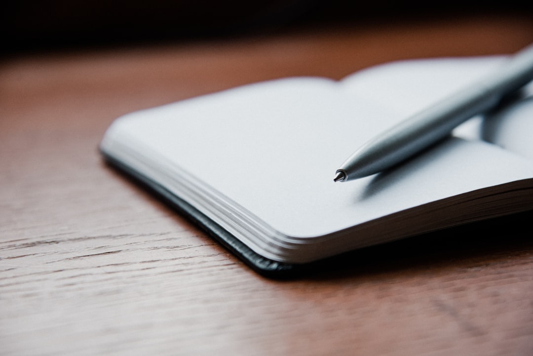 A pen resting on a blank notebook, ready for a penetration test checklist