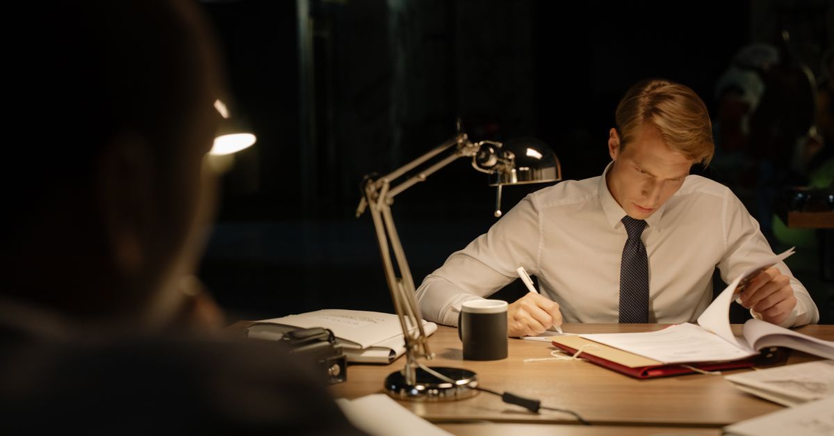 A professional reviewing paperwork at a desk, representing a child data compliance review