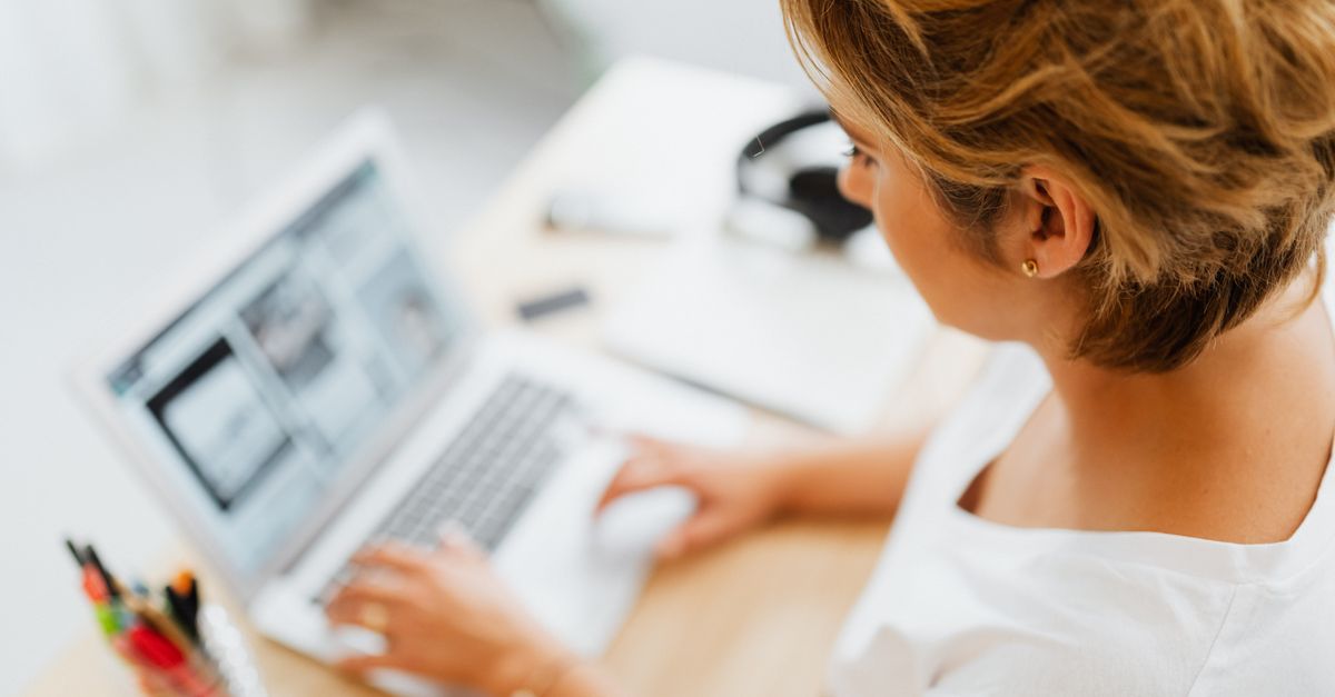 A small business owner working at a laptop after a penetration testing engagement