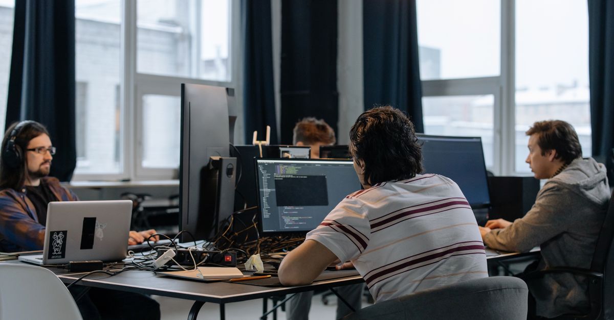 An IT team reviewing systems together in an office, the kind of check needed after new passkey attacks were disclosed