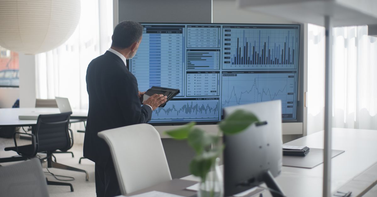 Business manager reviewing a data dashboard while checking systems for the Oracle WebLogic vulnerability