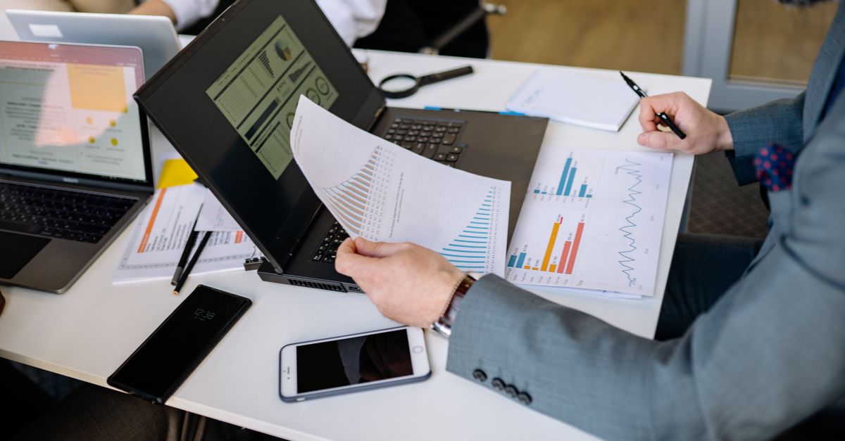 Business team reviewing printed reports at a desk after a PaperCut vulnerability disrupted print servers