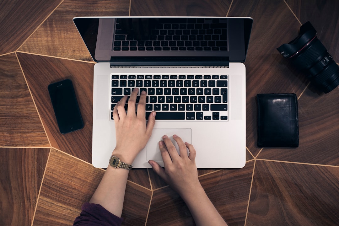 Close-up of hands typing on a laptop keyboard, representing an IT team working through the NetScaler patch
