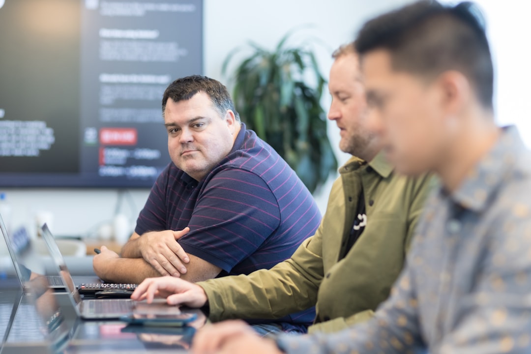 Colleagues reviewing findings on laptops during external attack surface management