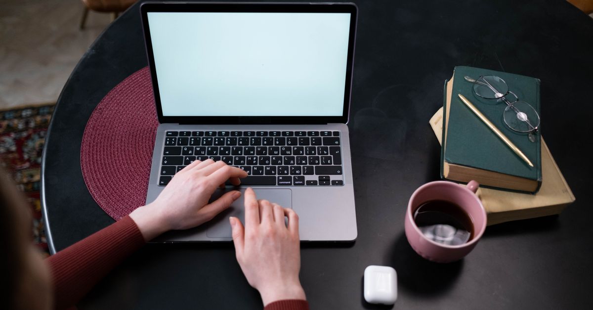 Hands on a laptop keyboard resetting a password flagged by credential monitoring