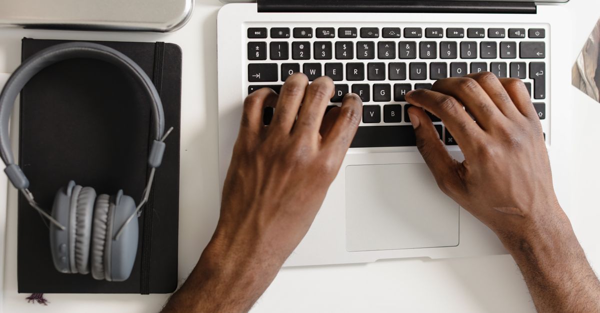 Hands typing on a laptop keyboard, representing a tester working from a foothold during assumed breach penetration testing