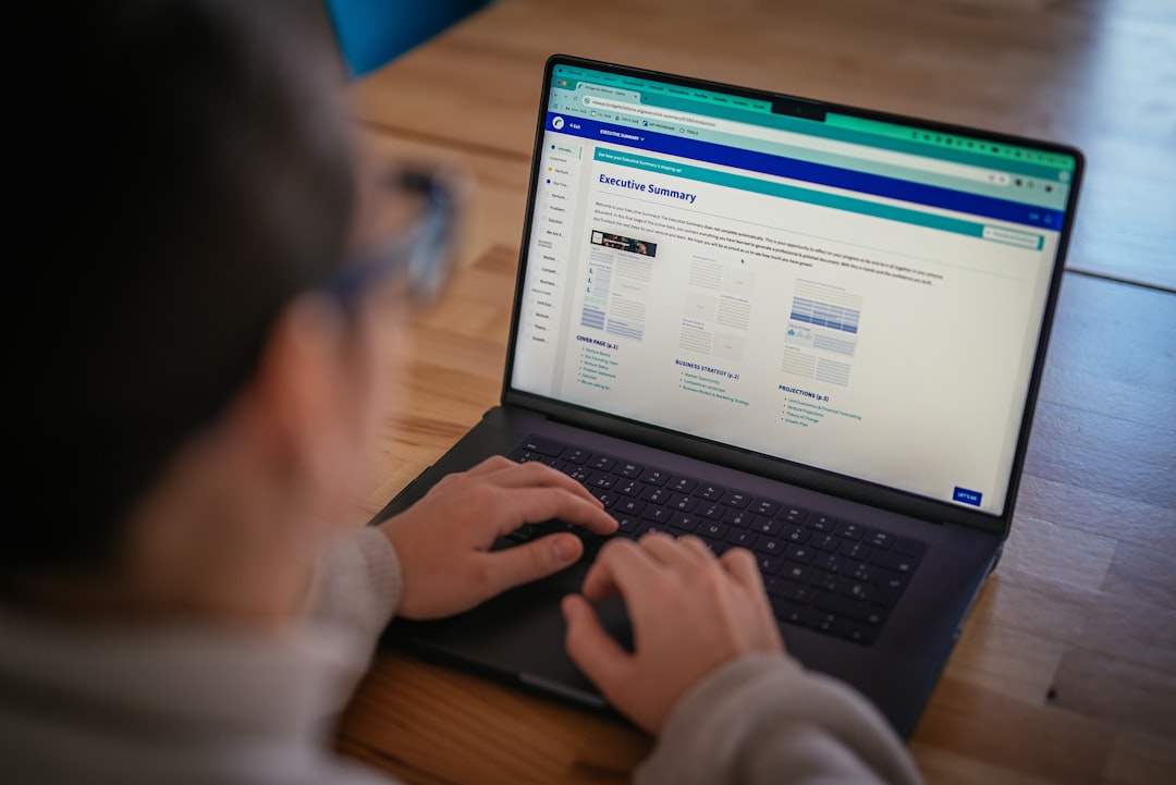 Reviewing a penetration test report on a laptop after commissioning outsourced testing