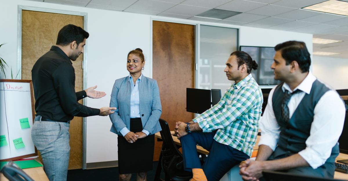 Small IT team discussing this week's critical vulnerability patching workload
