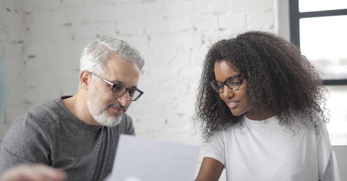 Two colleagues discussing a vulnerability report received under the company's disclosure policy