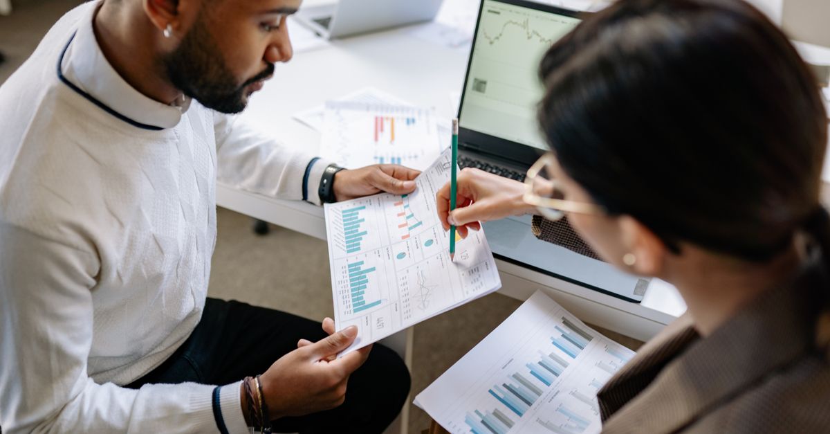 Two colleagues reviewing a penetration testing for law firms report and findings together at a desk