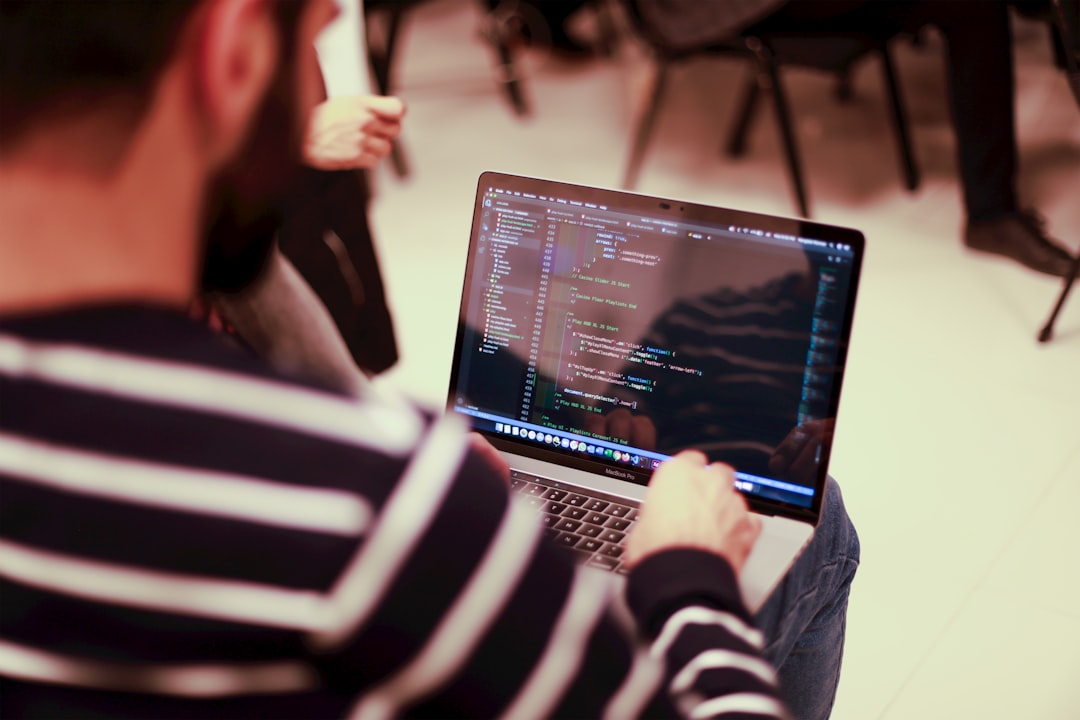 A penetration tester reviewing source code on a laptop during a white box penetration test