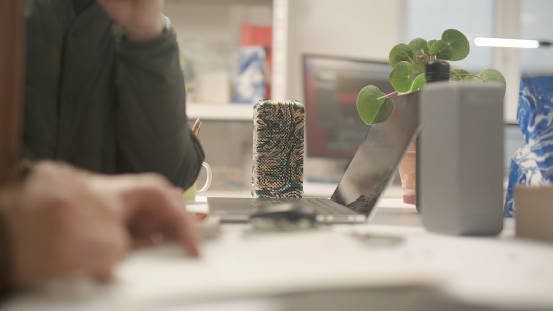 A quiet office desk with a laptop and monitor, mid-morning during this month's Patch Tuesday update
