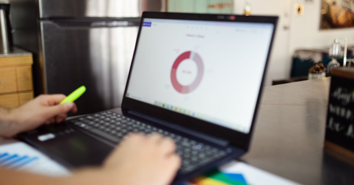 An IT manager reviewing a penetration testing report dashboard on a laptop instead of a certificate