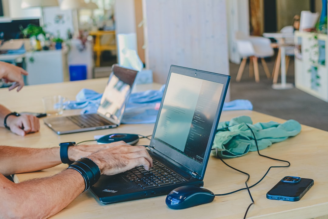 An office worker checking a website's plugin updates on a laptop as part of routine WordPress file upload security