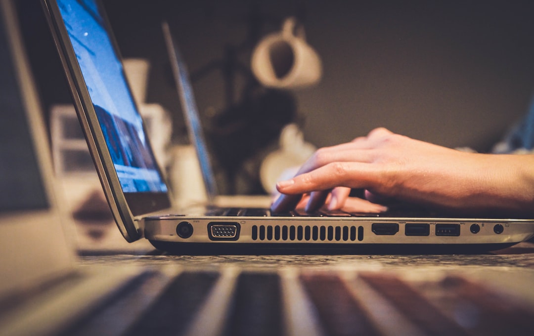 Close-up of hands typing a password into a laptop keyboard