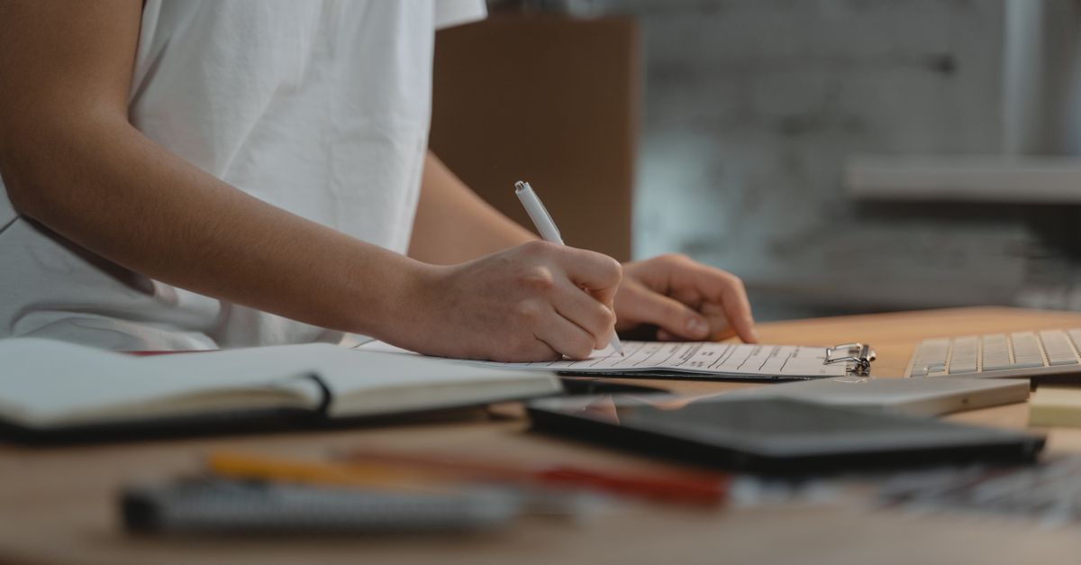 Hands filling in a provider checklist before buying penetration testing as a service