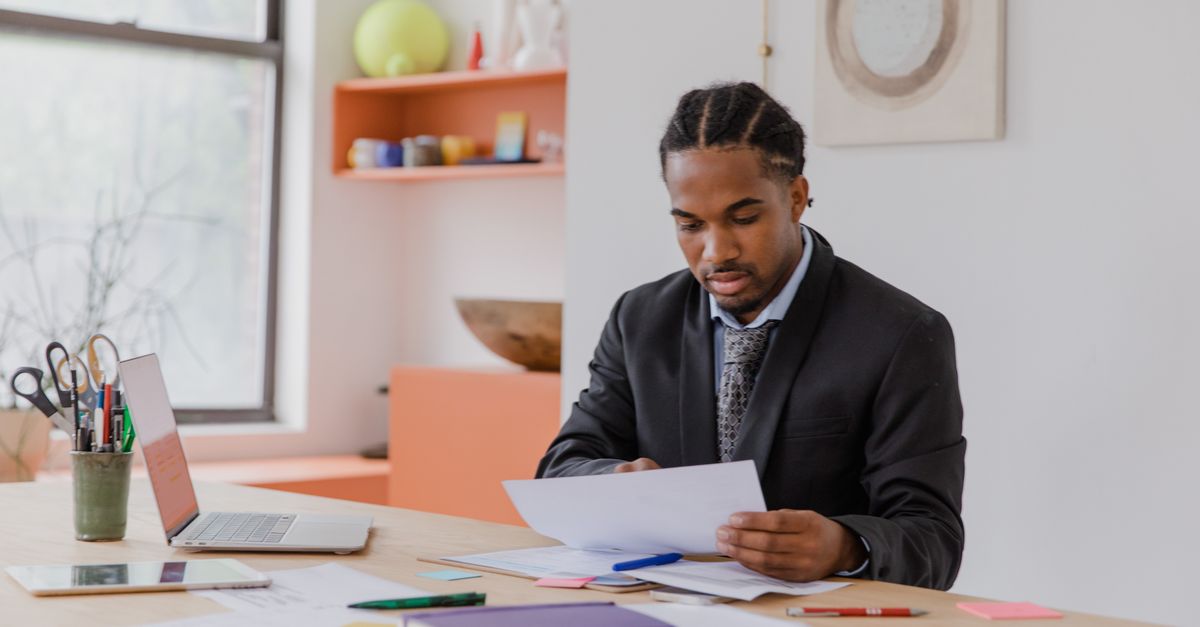 Business owner reading a supplier report, as penetration testing for MSPs results should be reviewed