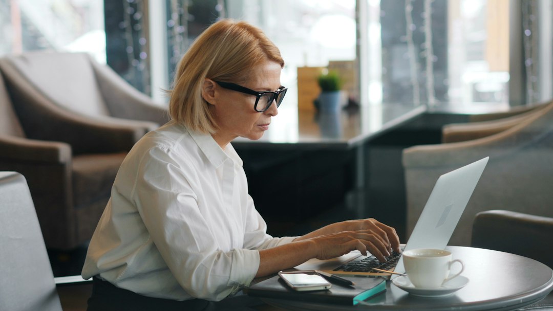 Employee typing a login on a laptop, the access that VPN credential theft targets