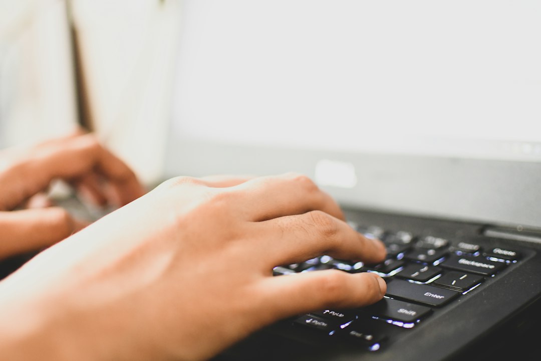 Fingers on a backlit keyboard as a user types a server login