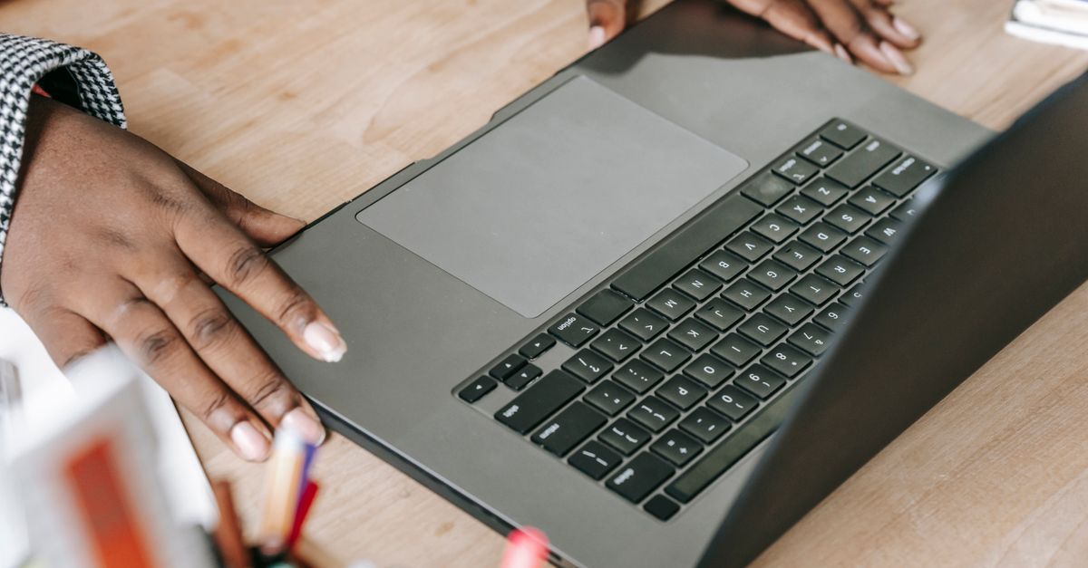 Hands on a laptop keyboard, ready to paste the command a fake ChatGPT page asks for