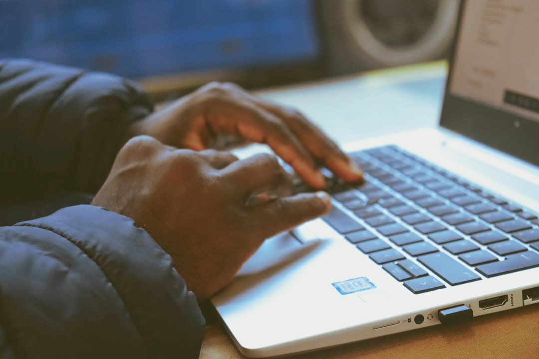 Hands typing on a laptop, standing in for an AI agent working on live websites