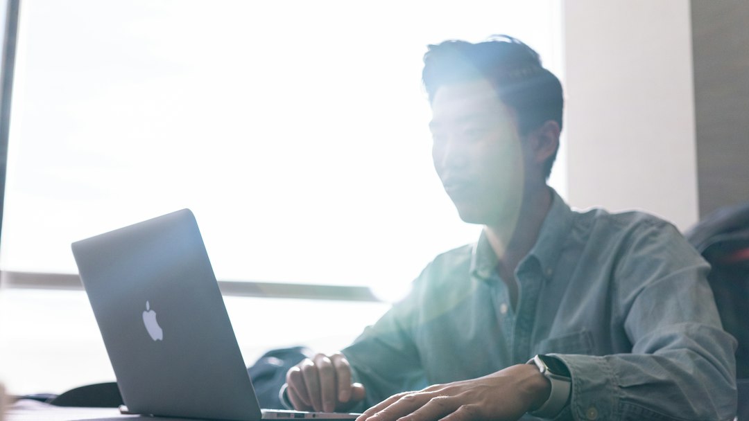 IT administrator at a laptop checking hosts for the PwnEscape vulnerability