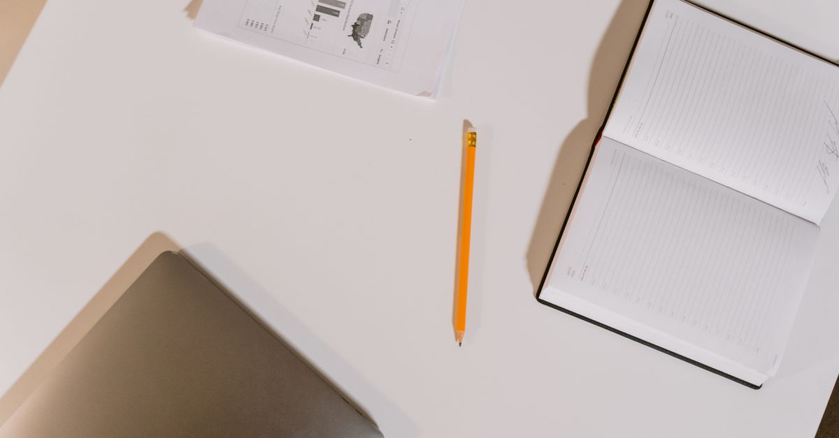 Notebook, pencil and printed report on a desk during a ransomware readiness assessment review