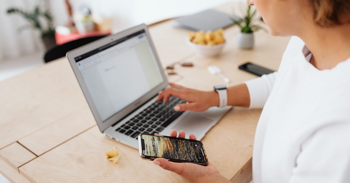 Phone beside a laptop, both exposed to targeted ad spyware