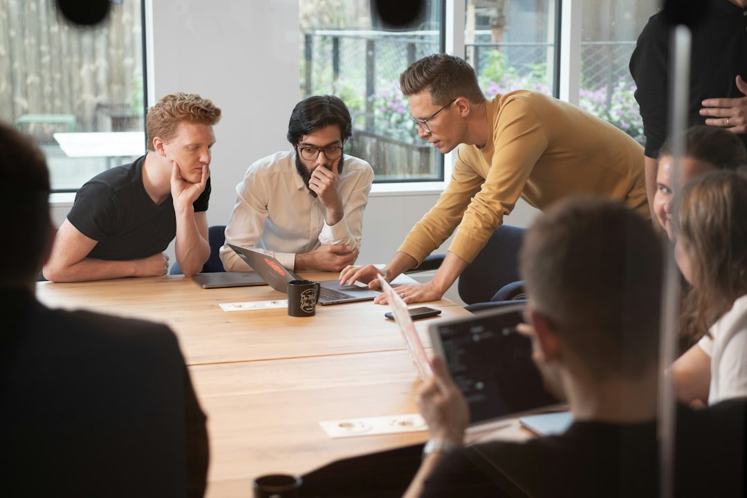 Security team gathered around a laptop reviewing ethical hacking findings