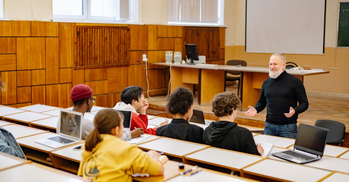 Students with laptops in a classroom, the kind of network penetration testing for schools examines