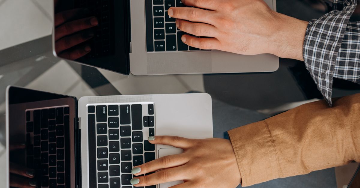 Two colleagues at laptops checking app permissions after the ConnectWise Cloud Backup breach